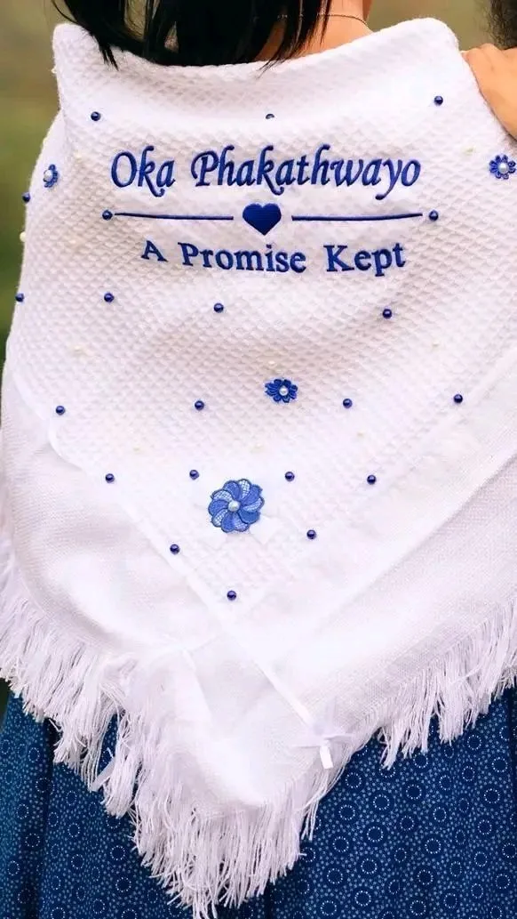 White isisholi traditional shawl embroidered with names and blue flower detail